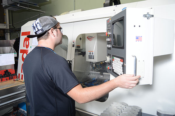 Man operating CNC machine